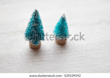 Artificial christmas trees with snow and gift boxes for background with copy space - shallow depth of field