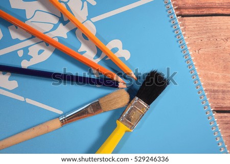 Picture book, pencils and brushes