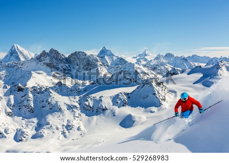 Skiing with amazing view of swiss famous mountains in beautiful winter snow. The matterhorn and the Dent d'Herens. In the background Castor and Pollux. In the foreground the Grand Desert glacier. Royalty-Free Stock Photo #529268983