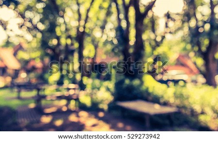 image of Abstract blurred outdoor coffee hut in garden on day time for background usage . (vintage tone)