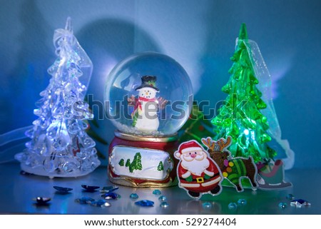 Santa Claus with Rudolf and sleigh with gifts, snowman, glowing trees and stars - Card