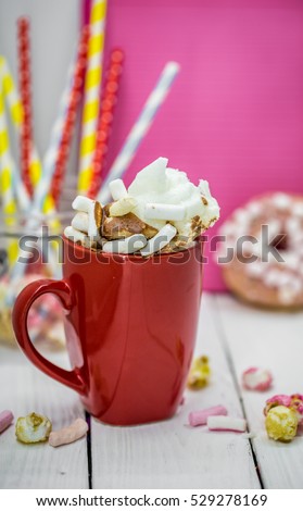 red Cup of fragrant cocoa and marshmallows, on wooden background