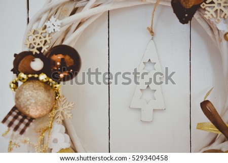Christmas Decoration Detail.  Holiday wreath on white wooden background for your staff
