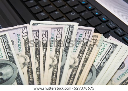 US dollars in closeup on laptop. 