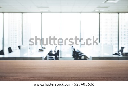 Empty wood table with blur room office and window city view background.For montage product display or design key visual layout.