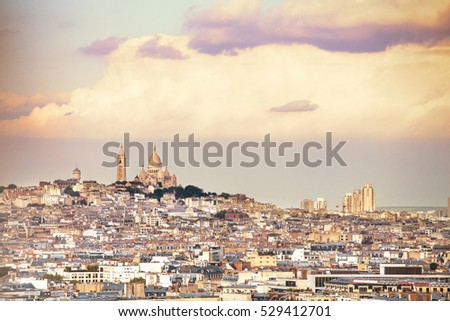 View of sunset over city scape with cloud background.