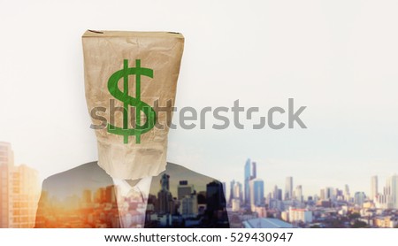 Businessman wearing crumpled brown paper bag, with green dollar sign, and double exposure cityscape in sunrise