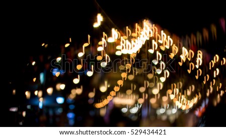 blurred abstract background christmas light with music note bokeh Royalty-Free Stock Photo #529434421