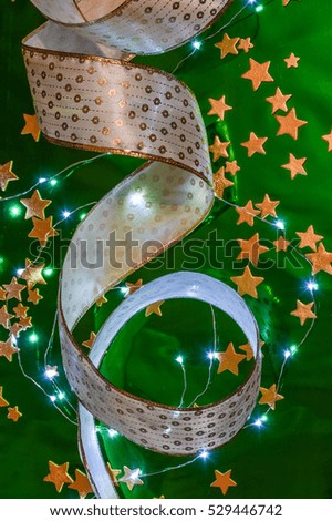 Christmas background with ribbon, golden stars and little lights