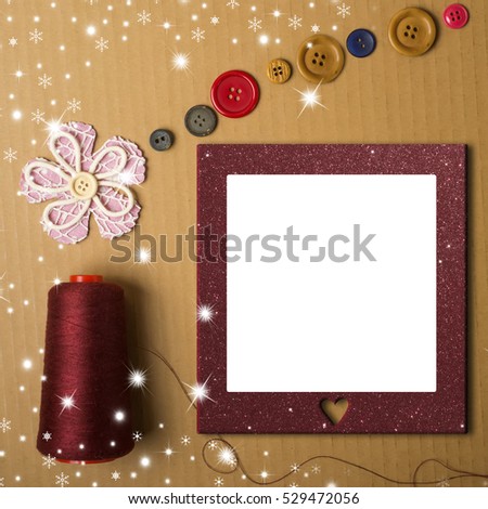 Christmas concept of sewing or crafts photo frame card, Christmas tree made with a coil of thread, flower fabric and buttons on a cardboard background with blank space.