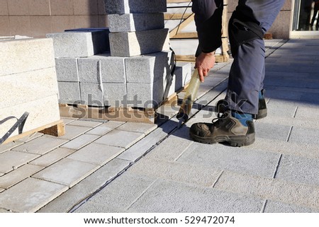 Construction worker pointing pavement