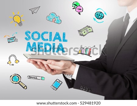 Social Media concept, young man holding a tablet computer