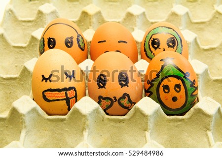 Christmas egg with faces drawn arranged in carton