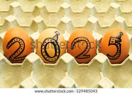 Happy New Year 2025! Four eggs arranged in carton