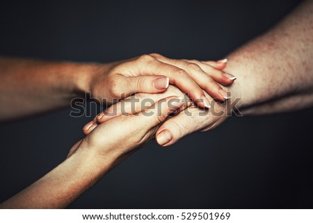 concept of care for older people and pensioners. Hands of the old and a young woman