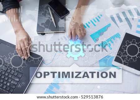 Woman is working with documents, tablet pc and notebook and selecting optimization.