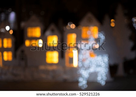 Defocused bokeh lights of christmas deer. Christmas day background.