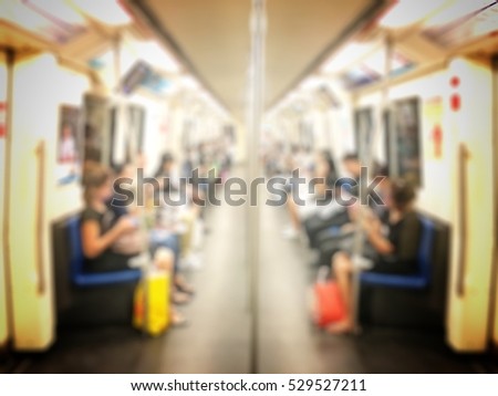 Blurred image of People Sitting and use smartphone on Mass Transit (Sky Train or Subway), Abstract Blur Defocus Background with vintage tone.