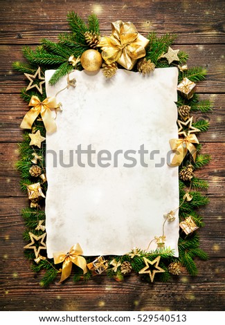 Old paper border with Christmas decorations on wooden background