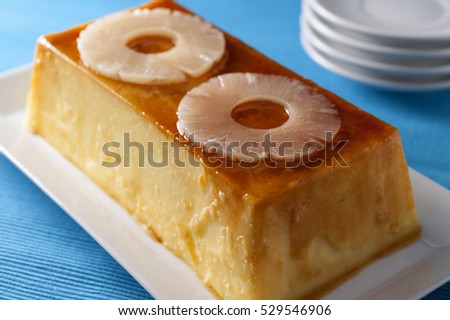pineapple pudding made with milk and gelatin, served with two slices of marinated pineapple
