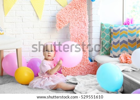 Portrait of one year-old baby girl indoors