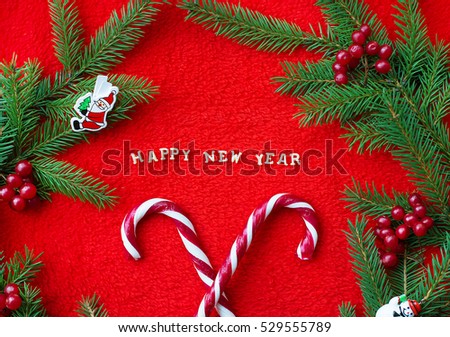 Christmas tree and candy on a red background with the words Happy New Year! Postcard