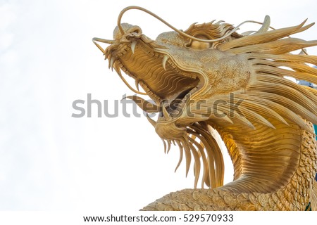 Chinese golden dragon statue in the background of blue sky