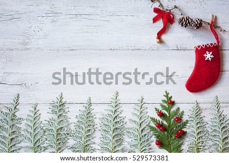 
Christmas wooden background with the symbol of the Christmas tree, red sock and  viburnum berries