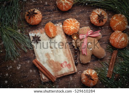 Christmas  Scenery  sets. Gingerbread little men with tangerines, cinnamon and an anisetree. An empty seat for the text. Studio shooting. Subject shooting.