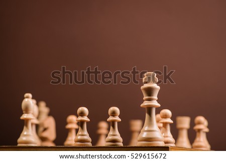 wood chess pieces on board game. brown vintage background