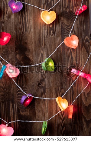 Bautiful color Fairy lights for St. Valentine's Day and Christmas on wooden background