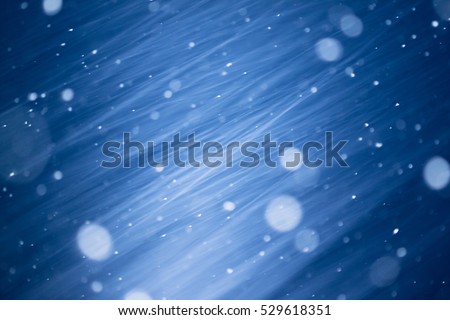 christmas background - snowstorm in the evening, lens blur bokeh 