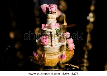 Picture of pretty tired cake with pink roses