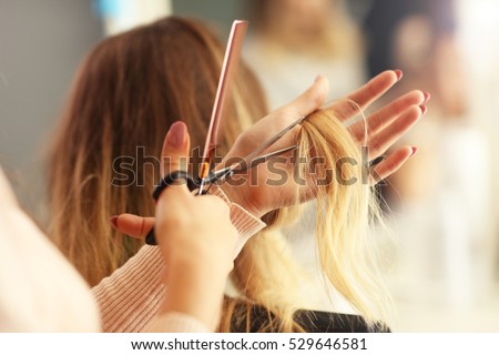 Picture showing hairdresser holding scissors and comb Royalty-Free Stock Photo #529646581