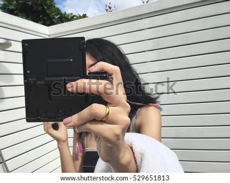 Woman using a camera to take photo