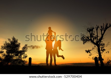 Happy family in the park at the sunset time.