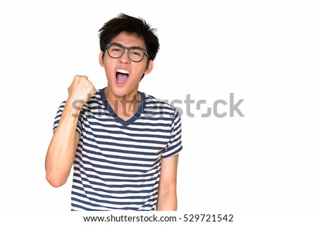 Studio shot of happy Asian nerd guy isolated against white background