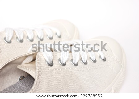 Minimalist white sneakers shoes isolated on white background