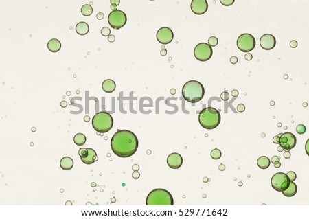 Green air bubbles soars over a light background
