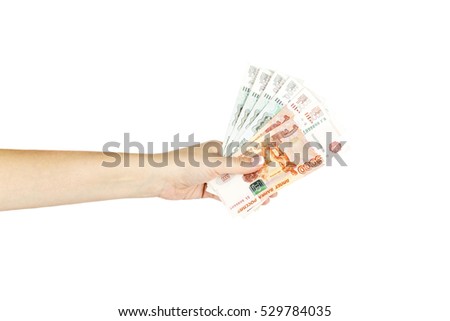 Isolated women's hand holds russian money on a white background.