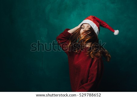 Beauty and fashion woman in Christmas hat cap is happy and content items.
