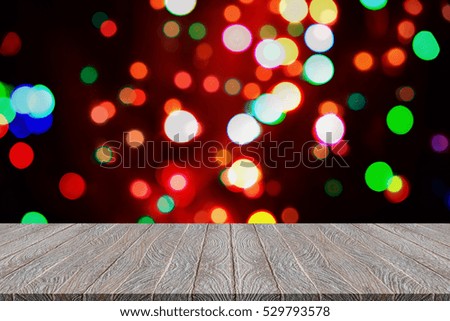Christmas bokeh background with empty wooden table. Perfect for product display montage
