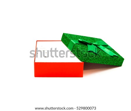Open and empty glitter Merry Christmas and Happy New Year's Day gift box isolated on white background. Sparkle tinsel gift box with ribbon. Clipping path and copy space.