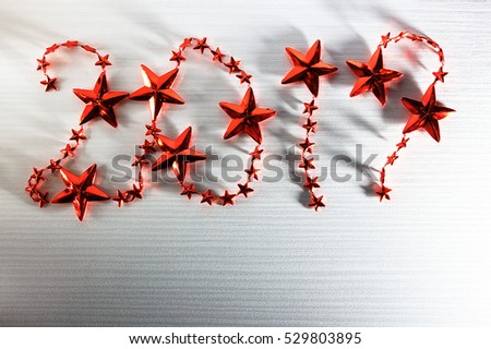 Christmas inscription 2017 red stars on white wooden background