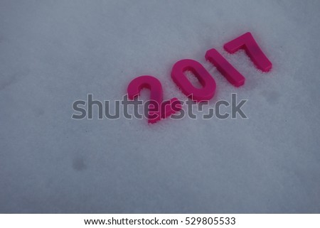 2017 new year. The numbers on the background. The red numbers on the white snow.