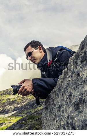 Photographer at work in mountains of Norway