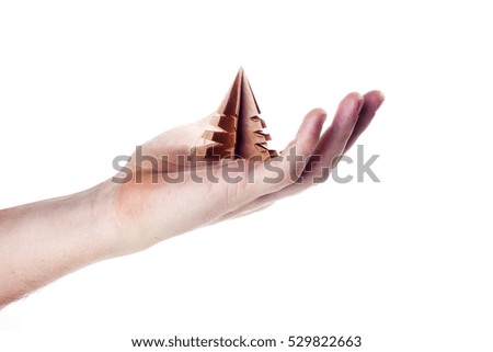 Hand holding a craft origami tree with isolated on white background.