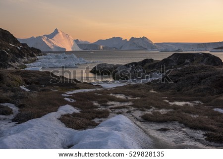 View of ilulissat's with icebergs summer night in Greenland