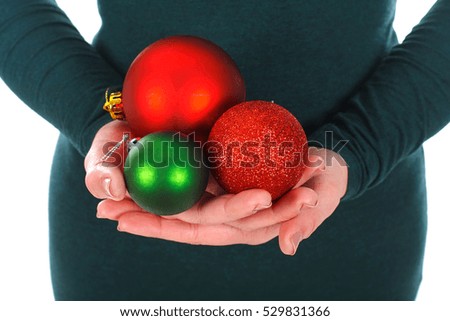 Close up picture of a woman holding Christmas decoration