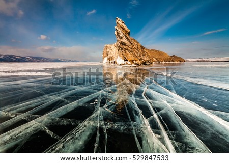 Transparent ice on Lake Baikal near Ogoy island. Siberia, Russia Royalty-Free Stock Photo #529847533